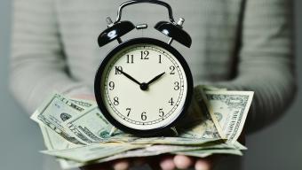 clock on pile of money