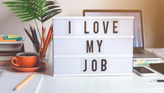 sign on desk that says "I love my job"