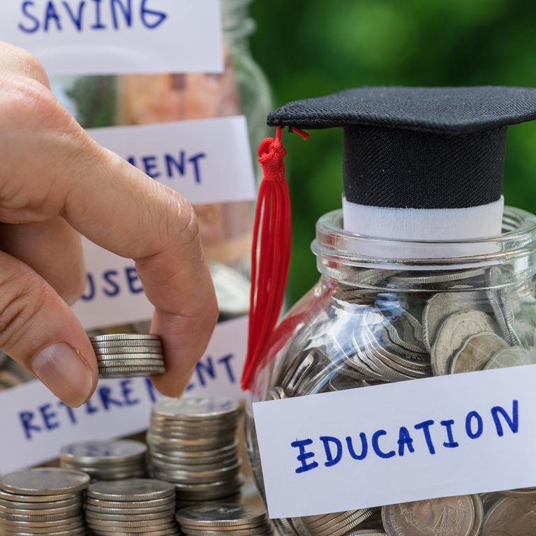 jar labeled education filled with coins